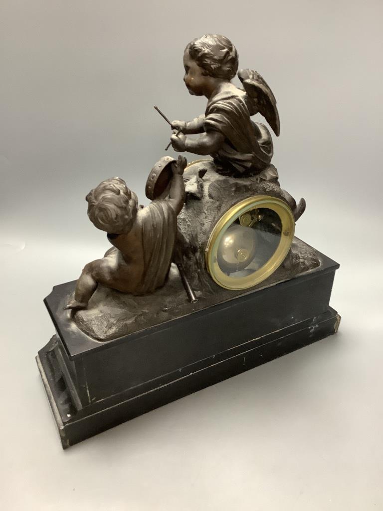 An early 20th century French spelter and slate cherub mantel clock, height 34cm